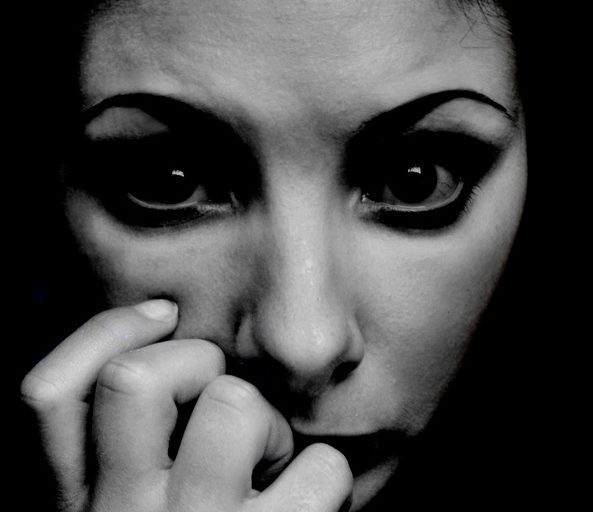 a very worried, stressed looking woman- with eyes that look like a deer caught in the headlights